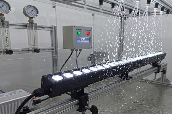 A linear light being tested for water resistance